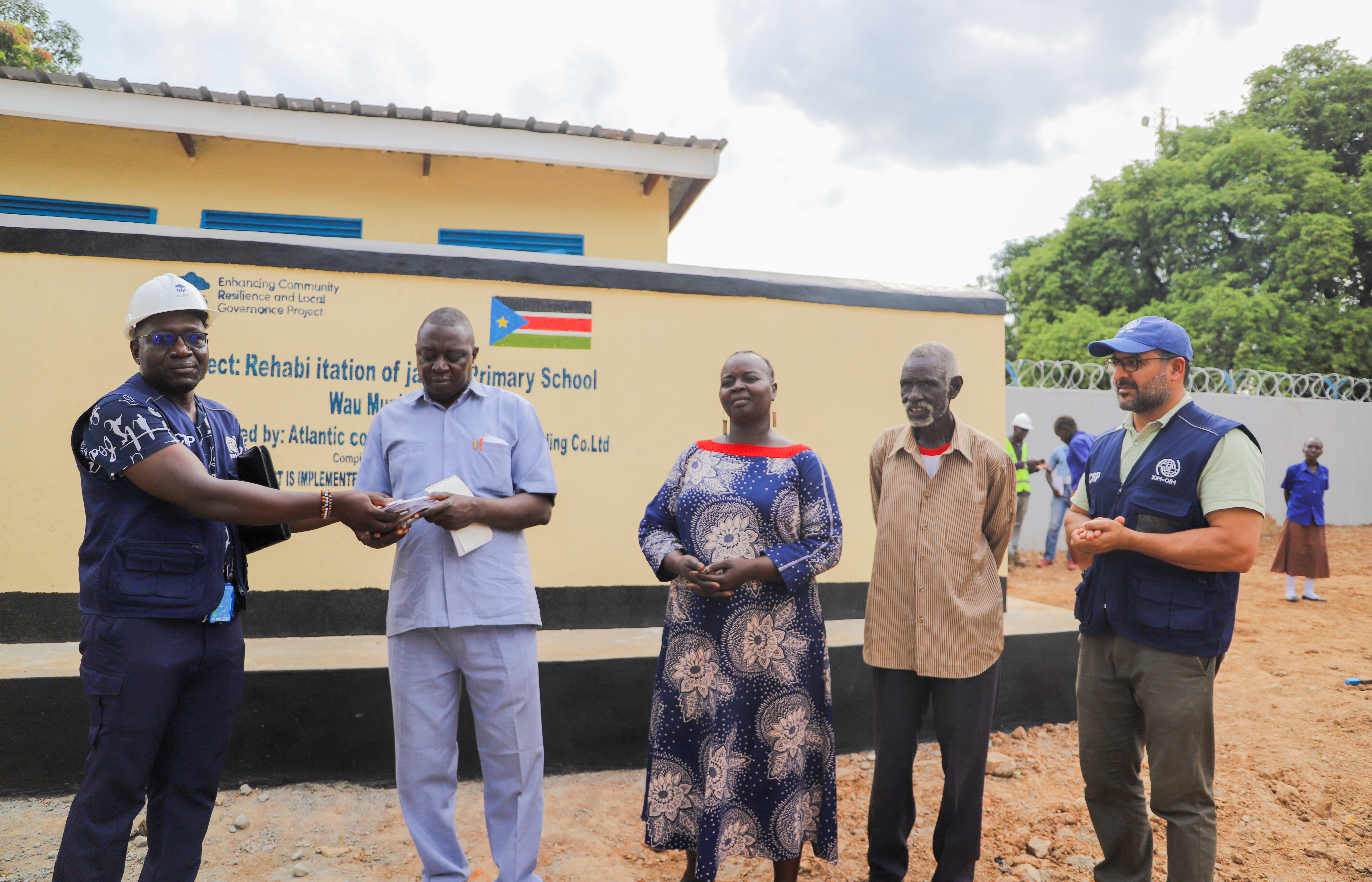 IOM team handover keys of the school to Chairperson of Payam Development Committee in Wau.