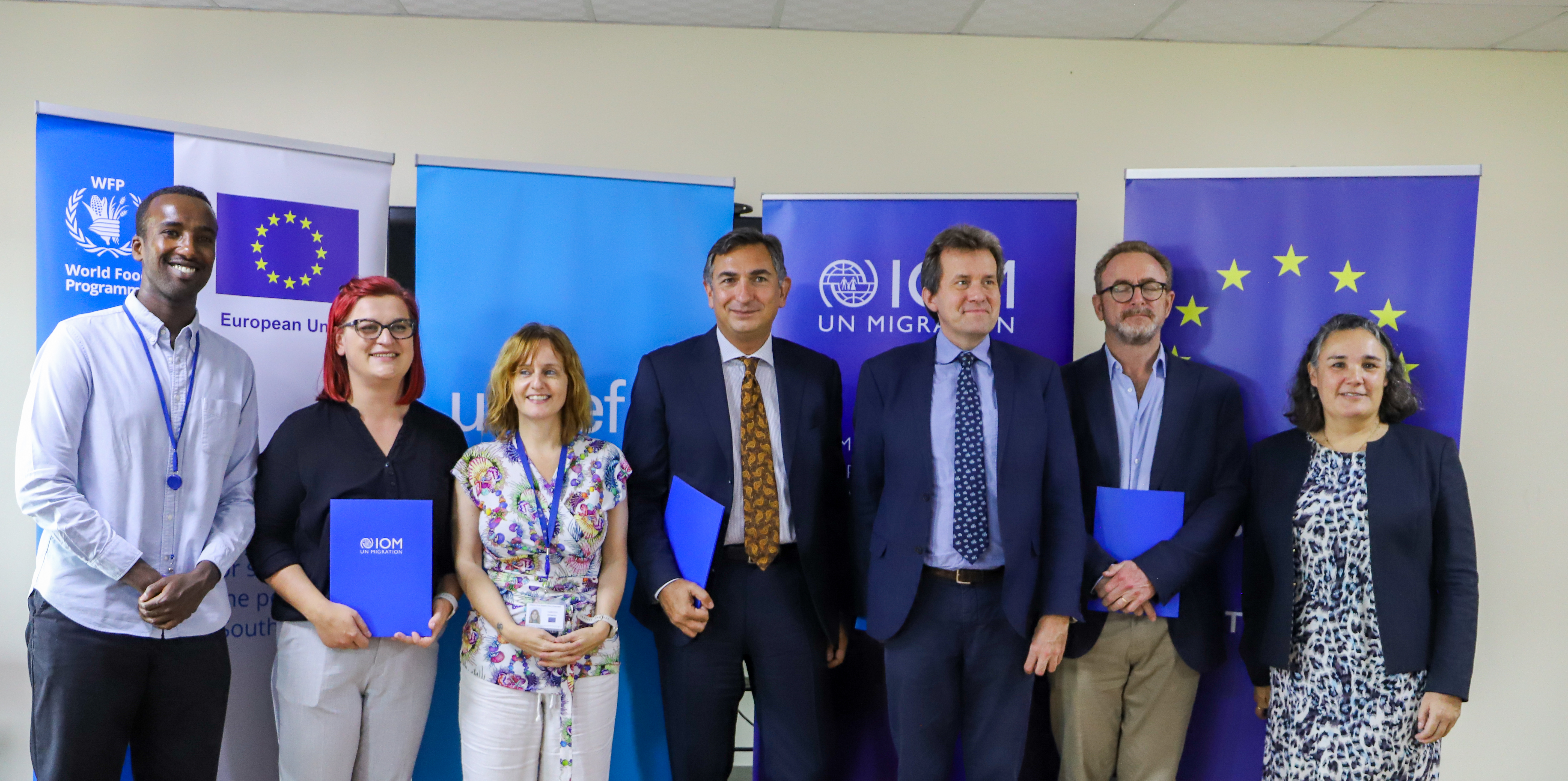 Group photo with the EU and representatives from IOM, UNICEF and WFP after the signing ceremony. Photo: Nabie Loyce