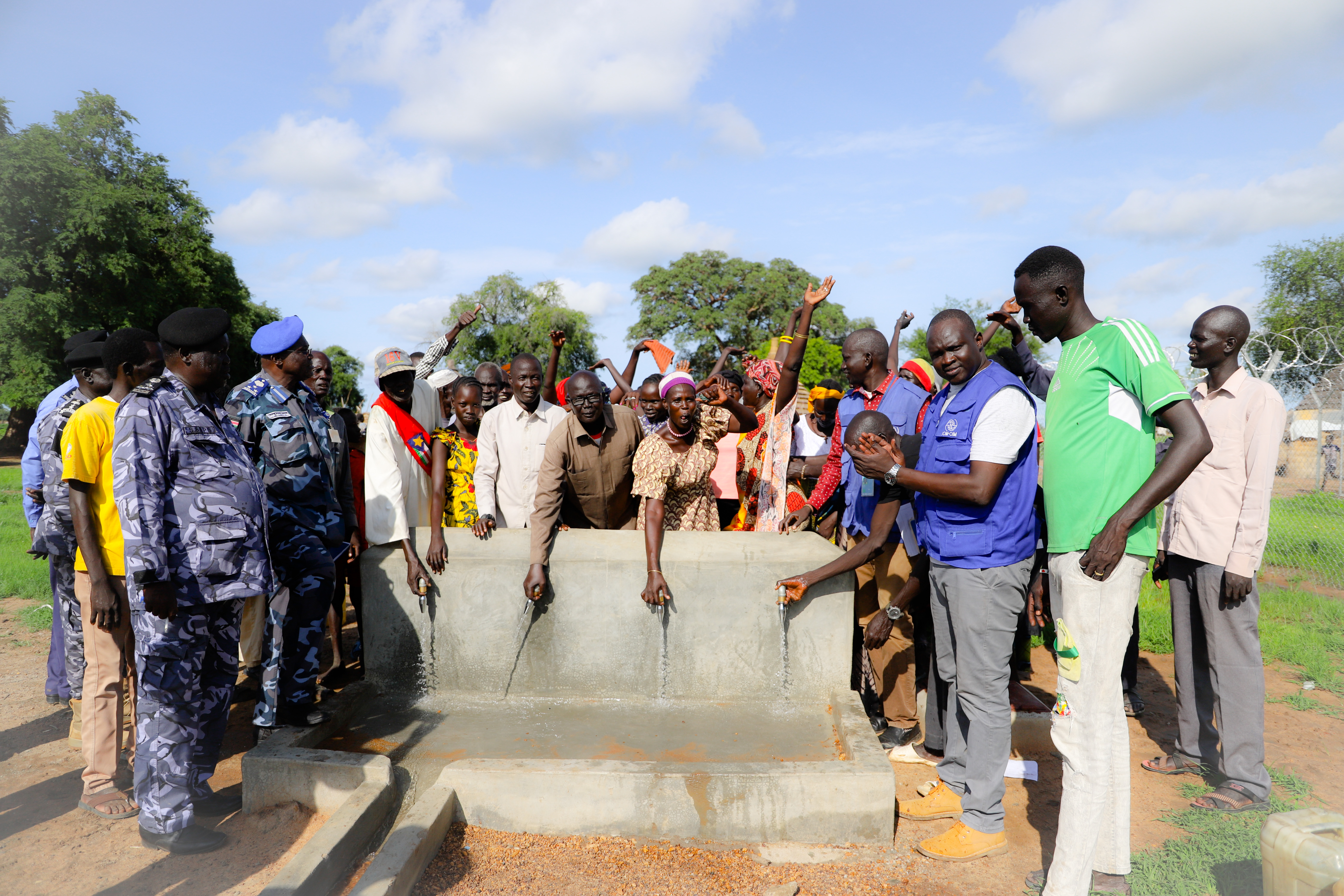 Community and authority test the taps of water collection point connected to the solarized water yard system in Majokyithiu. ©IOM/Nabie Loyce